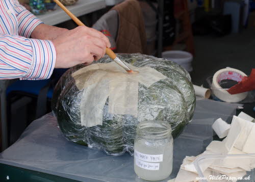 6.Place paper on paste on pumpkin